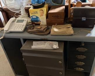 Black rolling office/storage cabinet with lamp, phone, containers and office smalls.