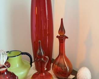 Red and green art-glass vases, decorative egg and tabletop pottery.
