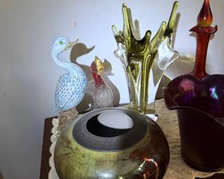 Art glass and pottery grouping with peacock bird, green/yellow bowl, purple vase and red bottle.