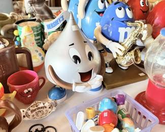 M&M's and Hershey's candy advertising collectibles with gumball-style dispensers and character pieces.