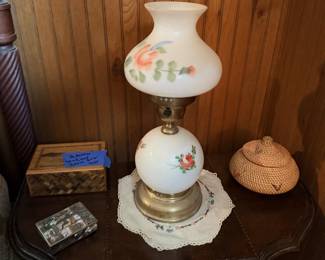 White milk-glass hurricane-style lamp with painted floral shade.