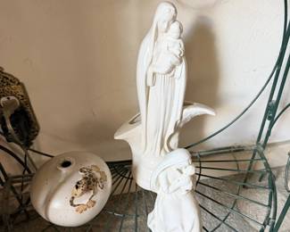 White religious or angel figure on wire plant stand with small floral dish.