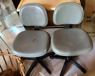 Pair of gray rolling chairs.