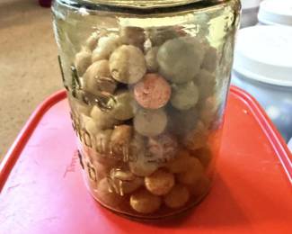 Jar of vintage clay marbles.