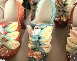 Pair of high-heel shoe ceramic planters or holders with floral accents.