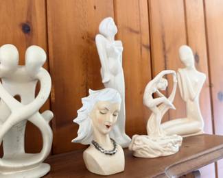 White figural sculpture grouping with bust, dancer and modern abstract forms.