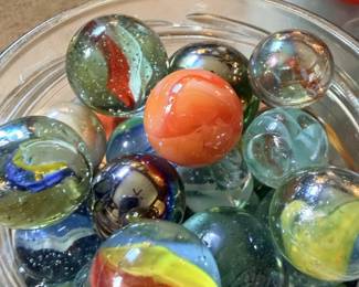 Close-up of colorful swirl, cat-eye and shooter-style marbles.