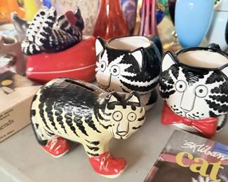 B. Kliban Cat red-sneaker ceramic figures with Kliban Cat book visible.