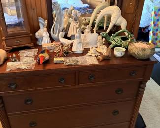 Wood dresser packed with pottery, animal figures, horn/antler decor, small sculptures and unusual estate collectibles.