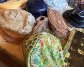 Hat lot with knit/woven hats, caps and small accessories on dresser.