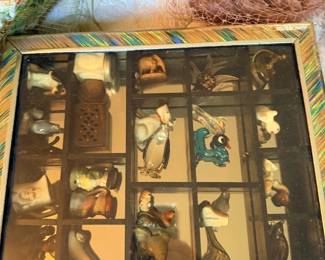 Miniature animal display case with figurines.