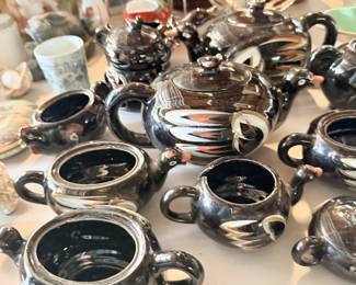 Black glazed teapot or cup lot with several matching lidded pieces.