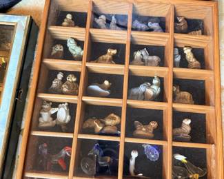Shadowbox/display case full of miniature animals, birds and small glass figures.