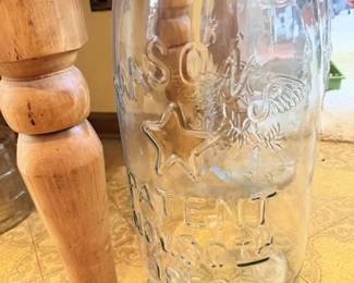Large embossed glass jar with raised lettering; vintage storage or display jar.