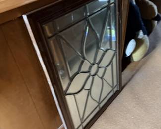 Stained-glass-style wall mirror or framed decorative glass panel.