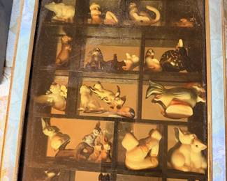 Framed display case with miniature animal figures and collectible smalls.