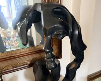 Black abstract female sculpture with curved body form.