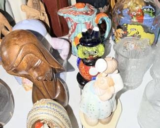 Mixed tabletop figures including horse head, ceramic character, clock and glass.