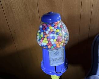 Gumball or candy-machine style toy filled with colorful balls.