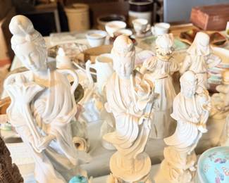 White classical/Greek-style figure grouping with seated figures and busts.