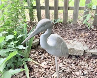 Single gray garden crane statue.