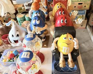 Large M&M's candy advertising character lot with basketball, saxophone figures and dispensers.