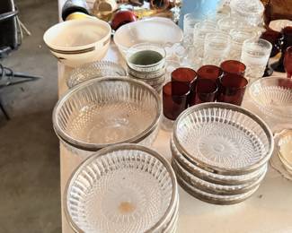 Clear ribbed glass plates and bowls with amber/red goblets.