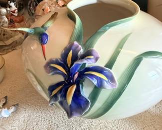 Large white and green ceramic pitcher or vase with applied purple iris flower.