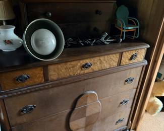 Wood dresser/chest with cubbies, shelves and mixed small decorative pieces.