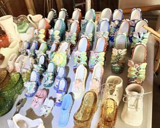 Decorative collectible glass and ceramic shoes.