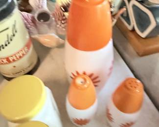 Orange and white salt and pepper shakers.