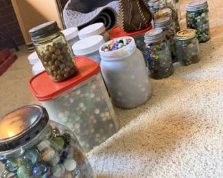 Jars of vintage marbles and game pieces; cat-eye, swirl and shooter-style collector lot.