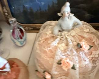 Pink textured covered dish or cookie jar with white finial and floral accents.