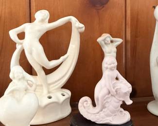 White abstract female/figure sculptures with one black-based piece.