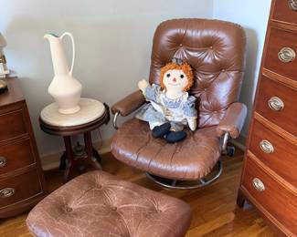 Brown leather swivel recliner and ottoman, photographed with doll for scale.