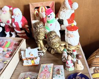 Christmas and winter tabletop lot with small village pieces, ornaments, figures and boxed decor.