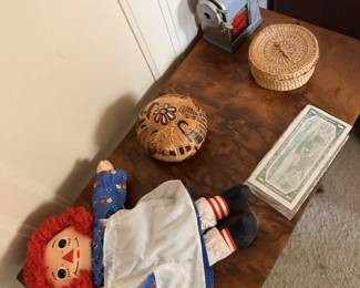 Raggedy Ann-style doll, carved or wood bowls, toy bank and small vintage toys.