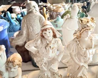 Featured shelf/table grouping with white sculptural figures, dogs, angel/girl figurines and mixed rare or unusual decor.