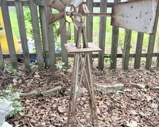 Metal wind spinner or yard stake with star/flower shape.