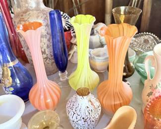 Colorful small vases and art-glass pieces in orange, yellow, blue and white.