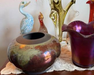 Art-glass bird and vase grouping with iridescent bowl, red bottle and green/yellow figures.
