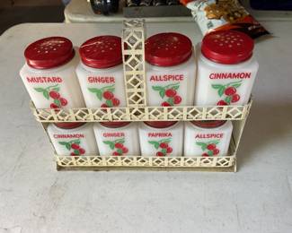 Vintage Tipp City milk-glass spice jar set with red lids and rack.