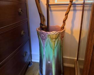 Glazed umbrella stand or cane holder with iridescent finish and wooden canes.