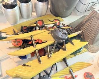 Yellow toy/model airplanes with small tools and novelty hardware pieces.