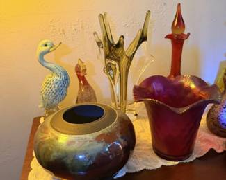 Second view of colorful art glass and pottery grouping with iridescent bowl, peacock and tall vases.