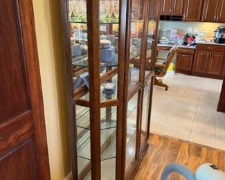 Beautiful, large, lighted glass curio cabinet. Lights up at top AND bottom to showcase! Cabinet is 51" x 16" x 77". I have a great local mover I can recommend if needed!