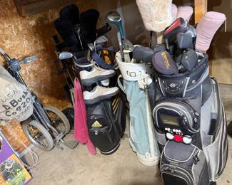 LOTS OF GOLF CLUBS, CARTS AND GOLF BALLS