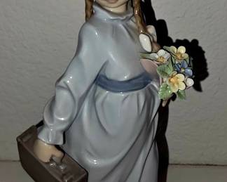 This is Lladró “School Days” #7604 — girl with suitcase/briefcase and flowers. It’s a retired Lladró Society-type piece.