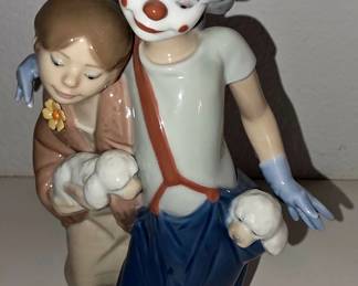 Lladró/NAO-style porcelain clown with child and lambs/dogs.