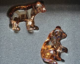Swarovski bear cub figurines, likely from the Rare Encounters / bear family line in amber/golden crystal.